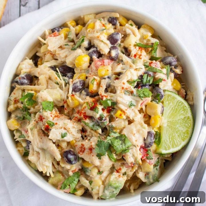 15 Quick Rotisserie Chicken Dinners for Busy Weeknights 8 Bowl of chicken salad with corn, black beans, avocado, and red bell pepper in a creamy dressing