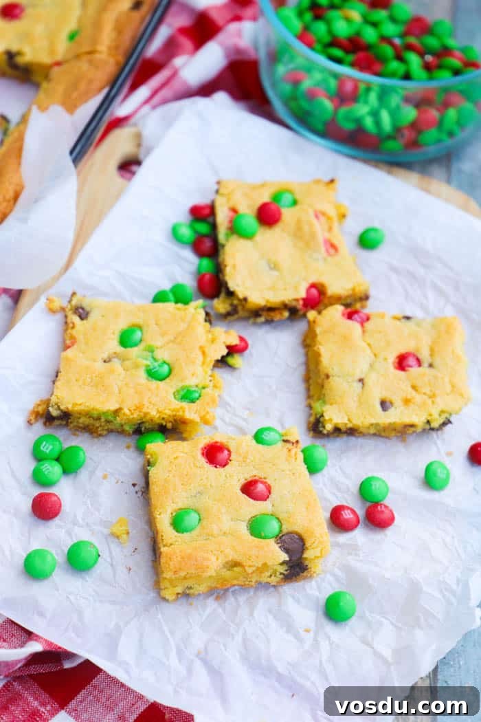 Festive Christmas Cake Mix Bars Recipe: Quick Holiday Dessert 4 Christmas Cake Mix Bars on parchment paper and M&Ms