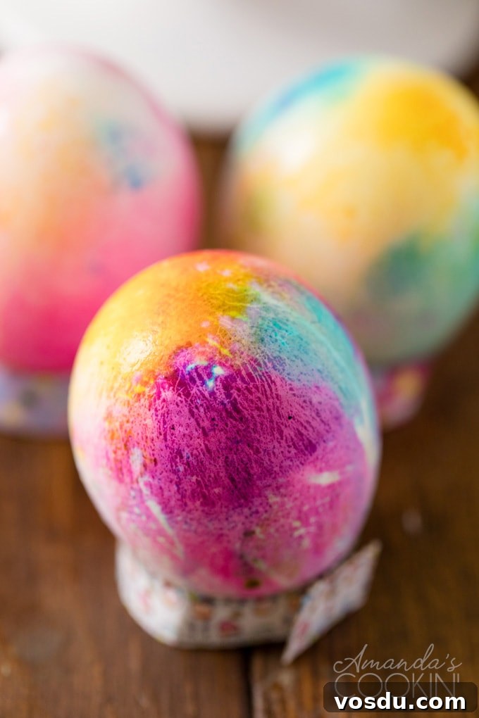 Tie Dye Easter Eggs are super fun for kids to get creative and create tons of different beautifully colored Easter eggs! Try these tie dye method this year! tie dyed easter egg