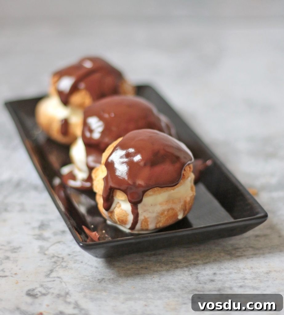 Classic French Profiteroles with Rich Chocolate Sauce 4 Three Profiteroles on a Plate
