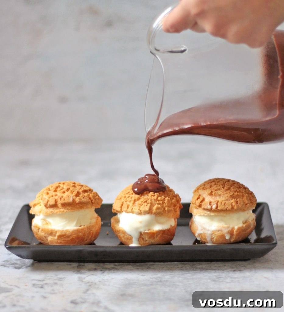 Classic French Profiteroles with Rich Chocolate Sauce 6 Pouring Chocolate Sauce over the Ice Cream Choux.