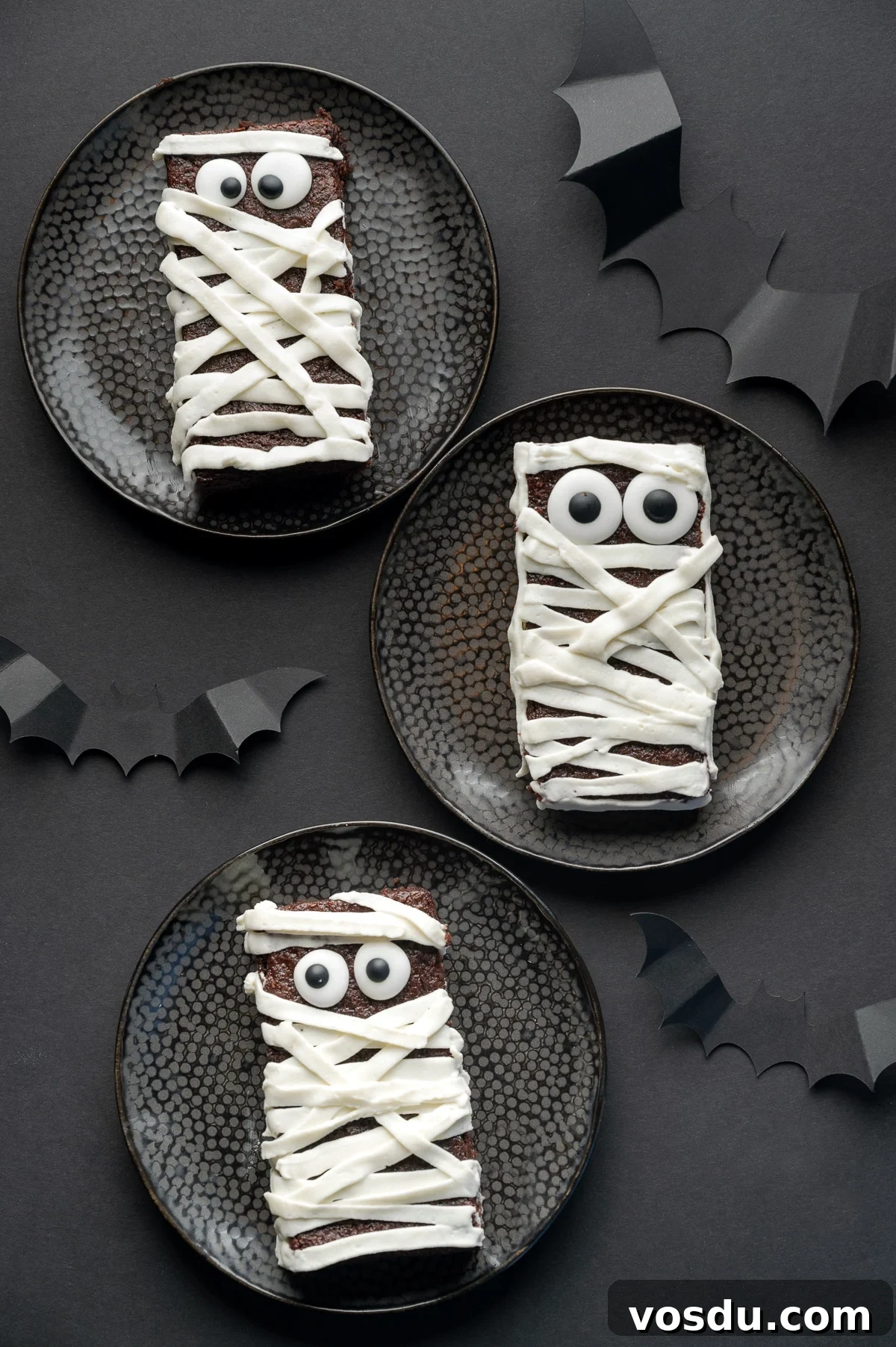 Halloween Mummy Sugar-Free Brownies — Gluten-Free Low-Carb Treats 2 Sugar free brownie with googly eyes and frosting applied in strips to look like bandages on a black background