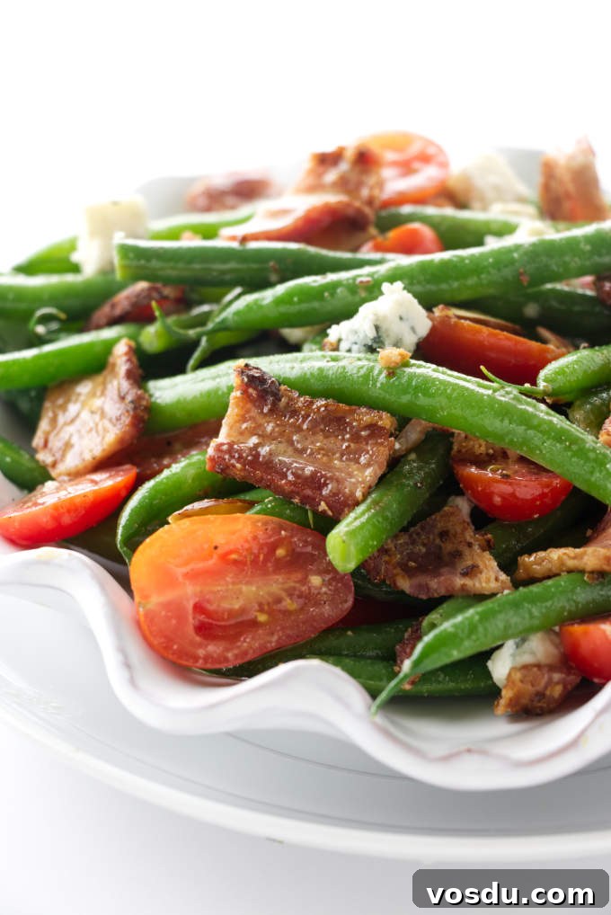 Crispy Bacon Tomato Green Bean Salad Recipe 6 Green bean and bacon salad on a plate.