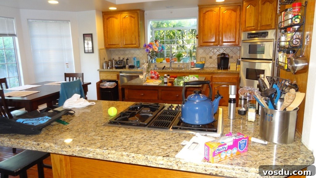 100 Clutter Challenge Before Colorful kitchen with granite countertops and wooden cabinets in a bright, inviting home.