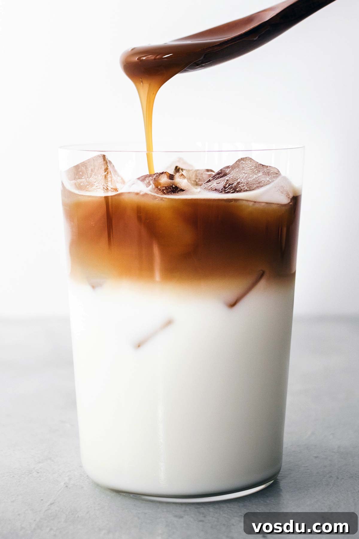 Carmel drizzled on espresso shots, ice, milk, and vanilla syrup, 