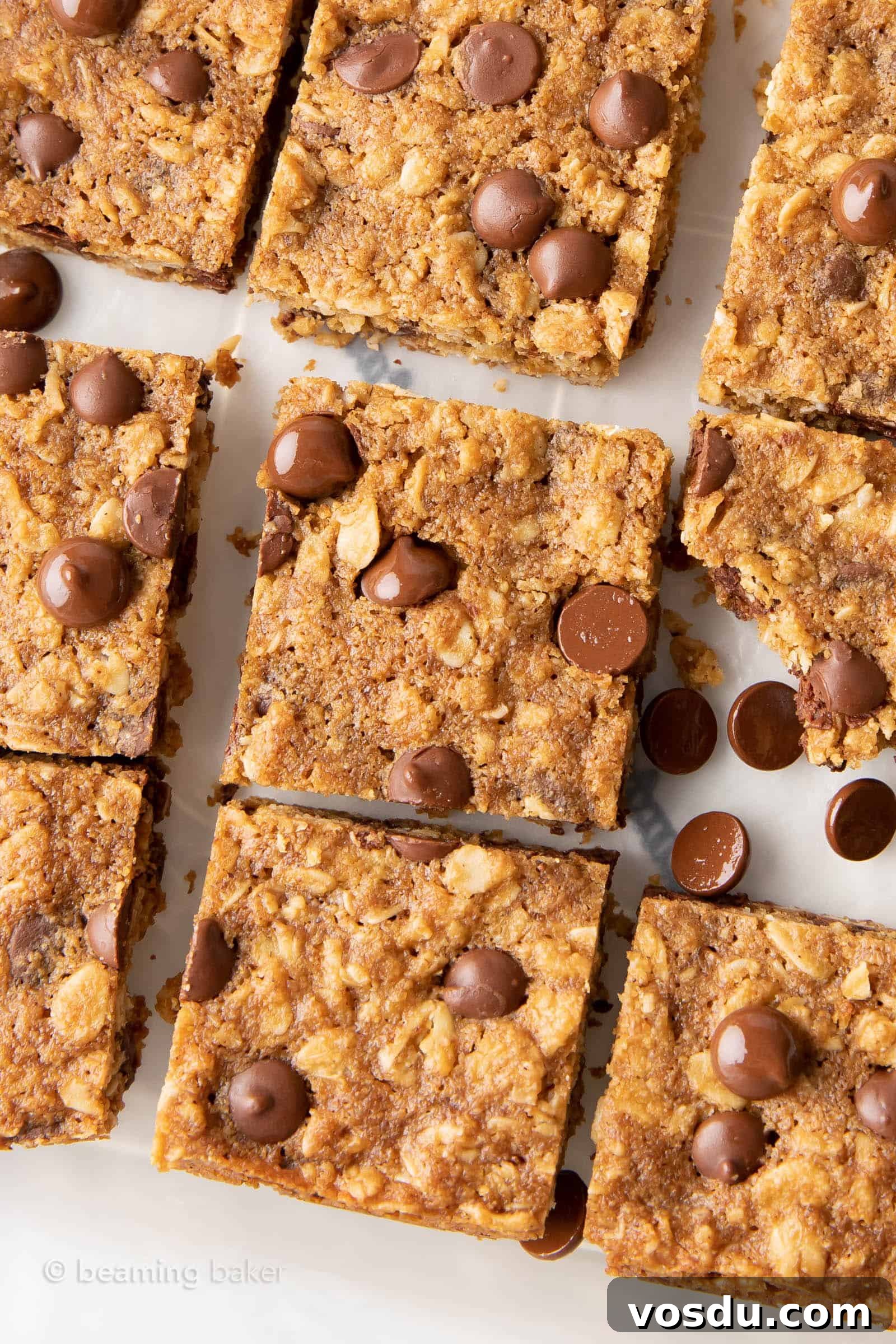 Oatmeal Chocolate Chip Cookie Bars with Wholesome Ingredients 3 oatmeal cookie bars sliced and cooling on parchment paper