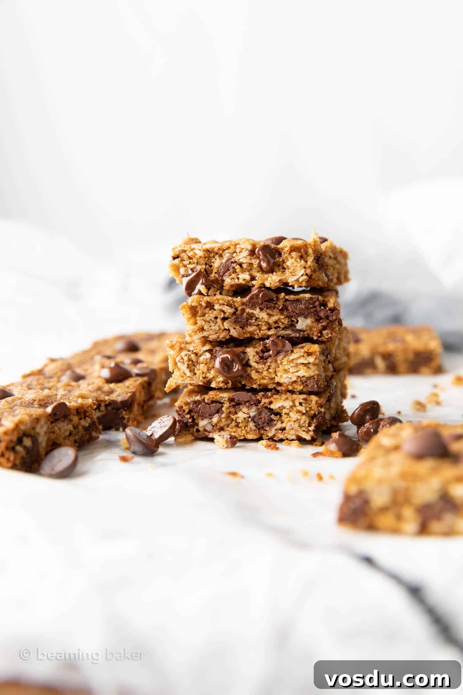 Oatmeal Chocolate Chip Cookie Bars with Wholesome Ingredients 4 faraway stack of oatmeal chocolate chip cookies bars with more in background
