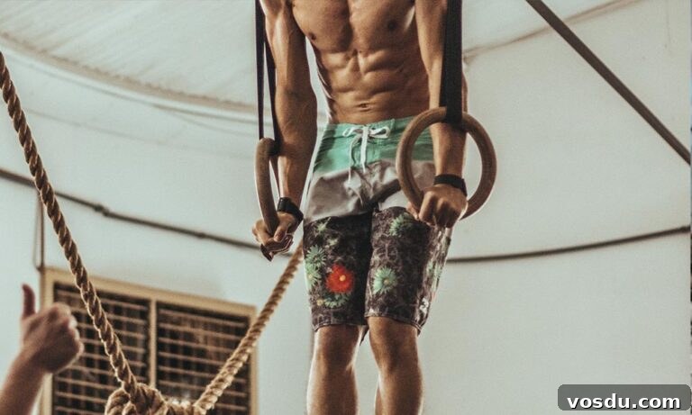 A man doing exercise with a hanging exercise equipment.