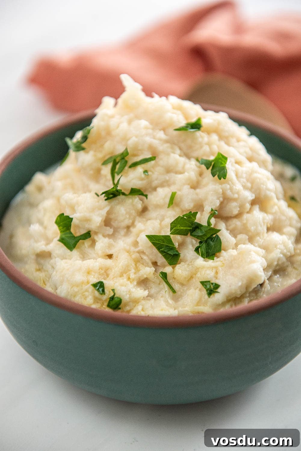 Slow-Cooker Whipped Cauliflower Recipe for Creamy Mash 11 green bowl filled with mashed cauliflower