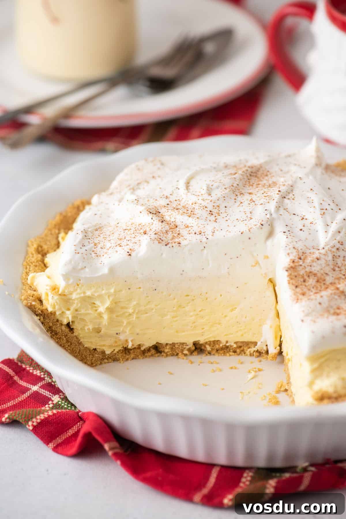A no bake eggnog pie with a slice missing