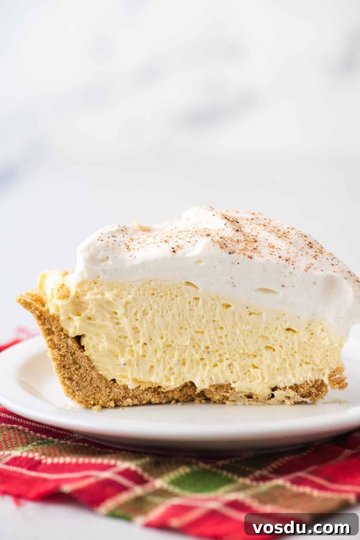 A slice of eggnog pie on a white plate