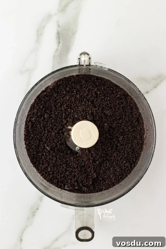 crushed Oreo cookie crumbs in the bowl of a food processor