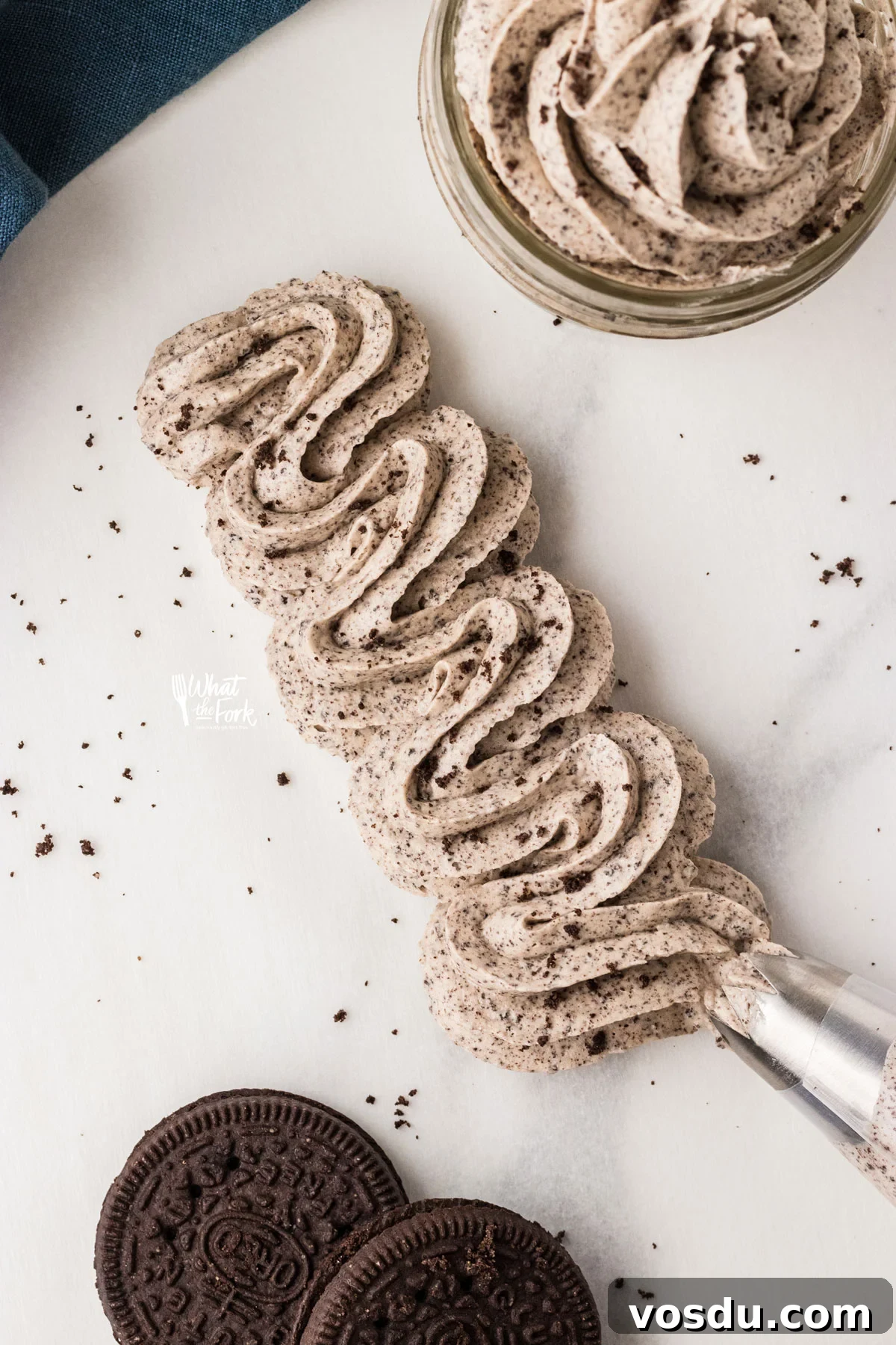 Cookies and Cream Frosting Recipe piped onto a flat surface with an open star tip.