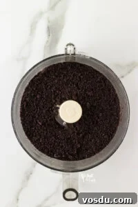 crushed Oreo cookie crumbs in the bowl of a food processor