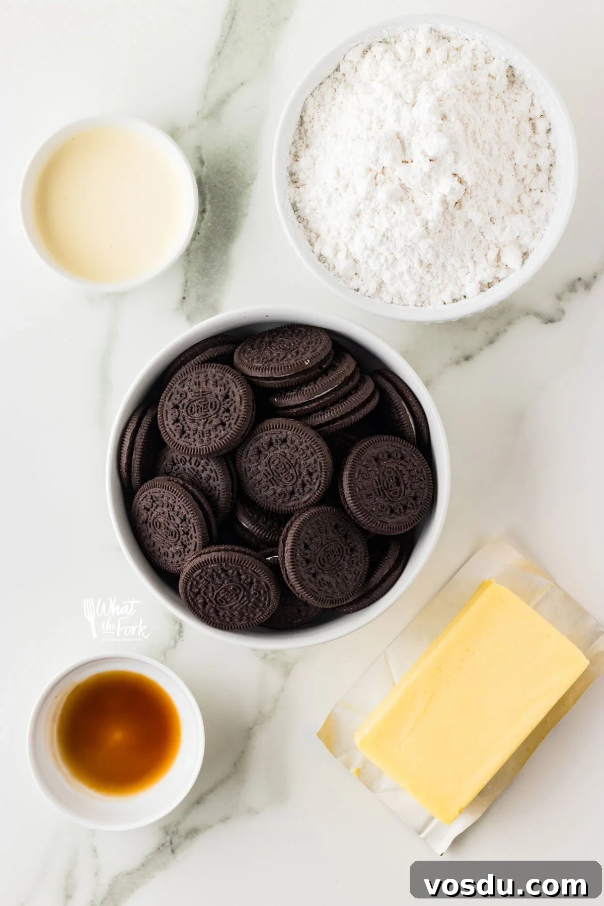 ingredients in individual bowls to make a Cookies and Cream Frosting recipe
