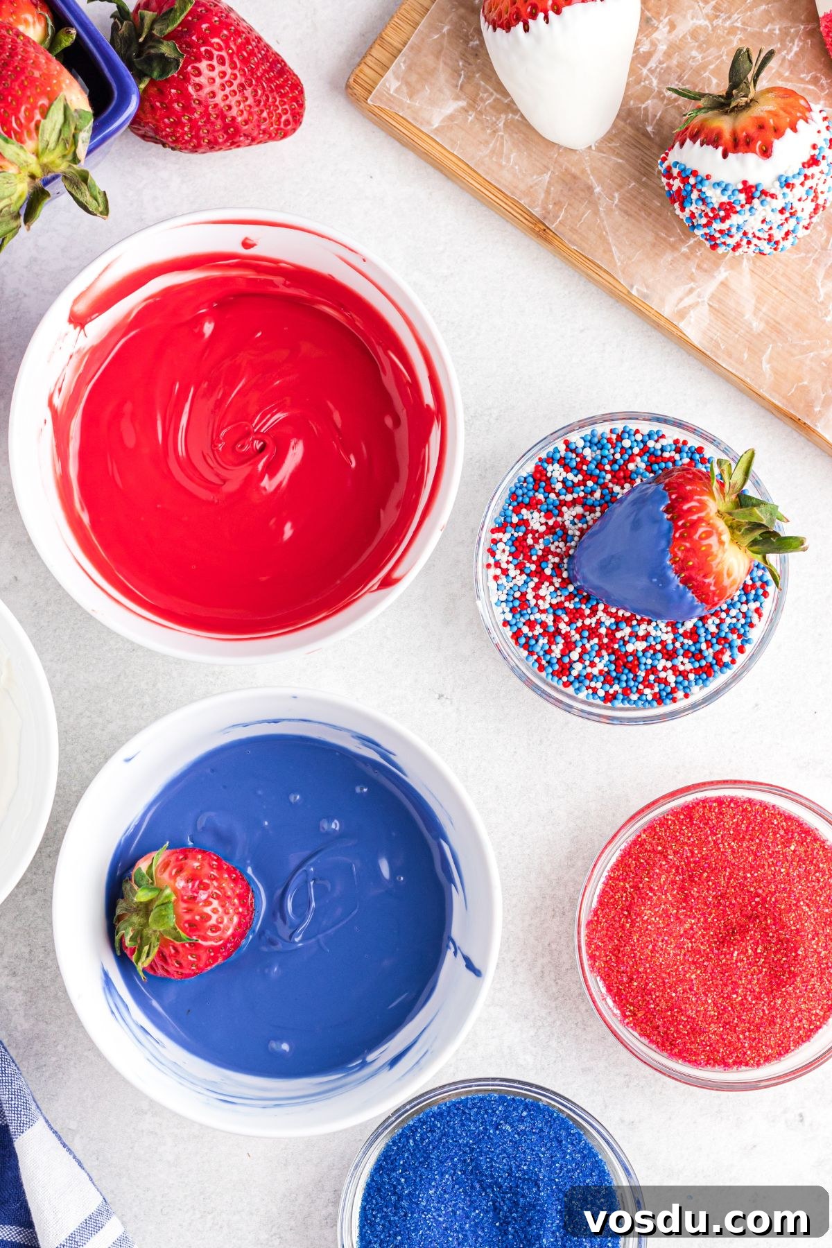 Melted red, white, and blue candy melts in small white bowls.