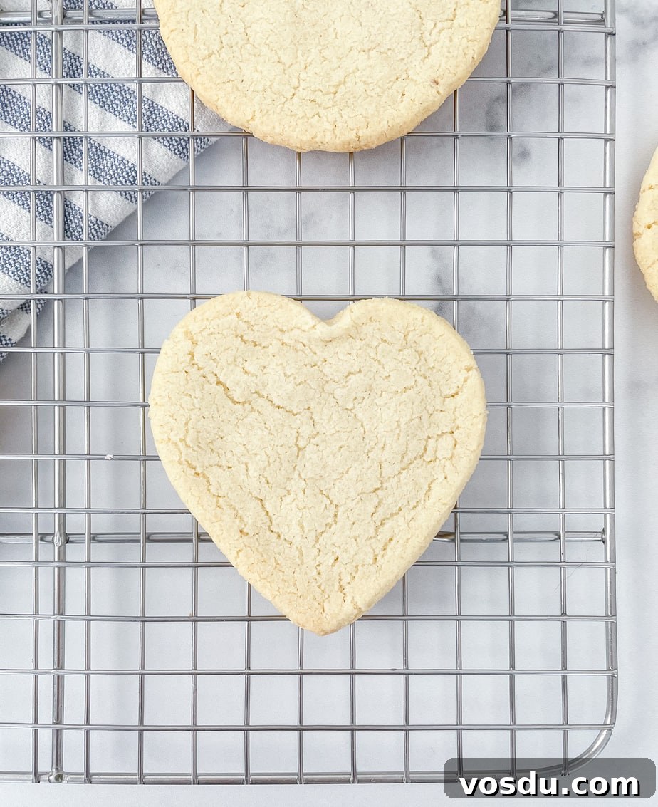 Almond Flour Shortbread Cookies Recipe — Buttery Gluten-Free Treat 3 Uniced heart shaped cookie cooling on a wire rack
