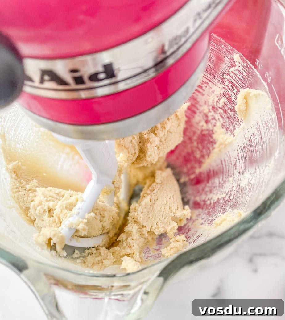 Almond Flour Shortbread Cookies Recipe — Buttery Gluten-Free Treat 5 Mixing the cookie dough in a pink mixer with the paddle attachment.