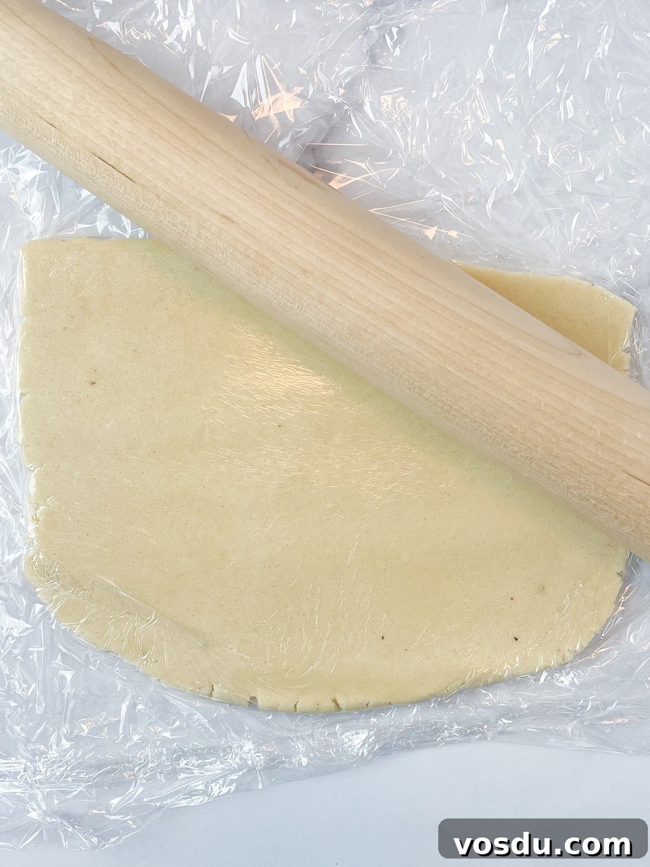 Almond Flour Shortbread Cookies Recipe — Buttery Gluten-Free Treat 7 Rolling the cookie dough out between two pieces of plastic with a rolling pin