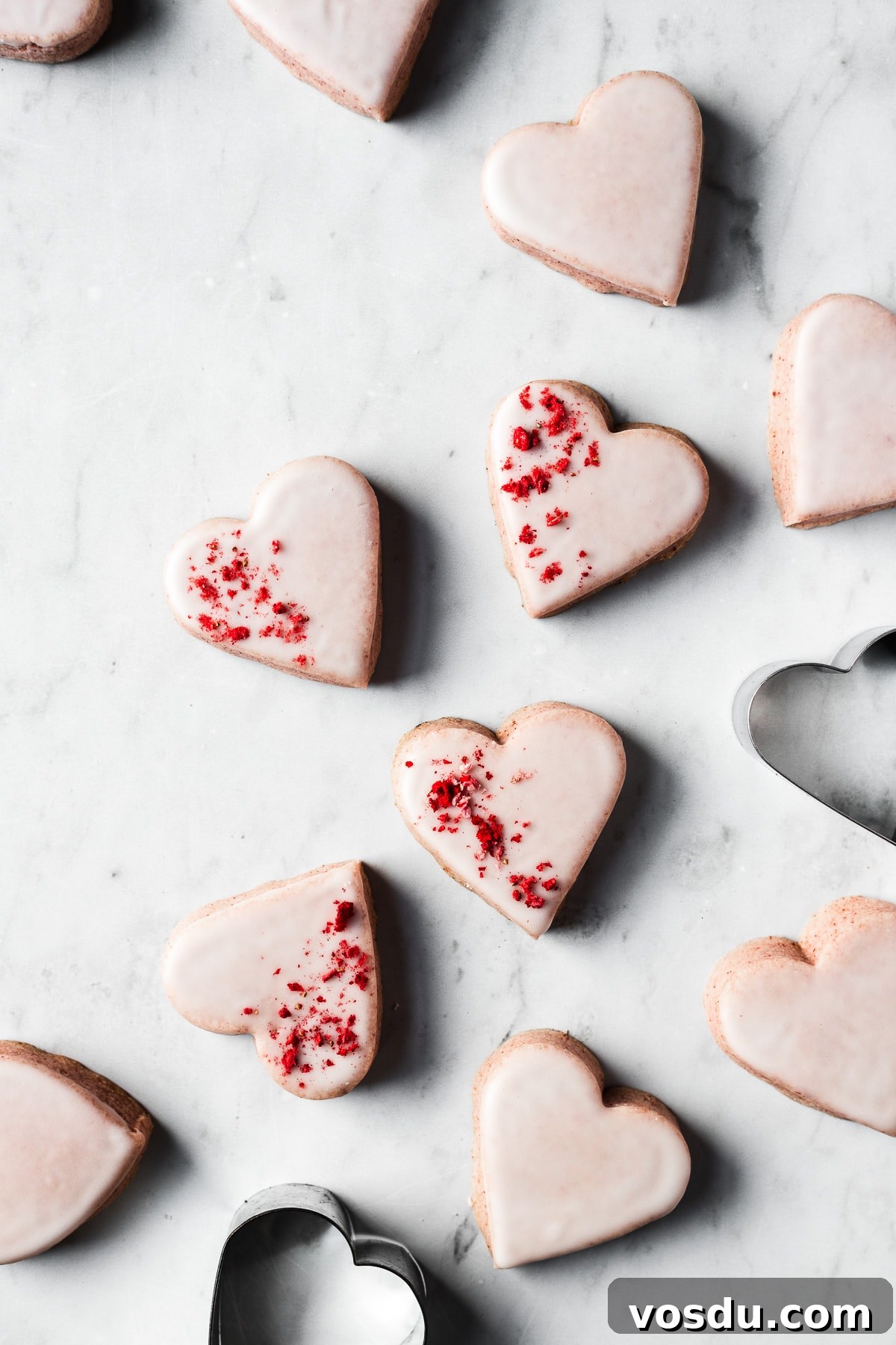 Strawberry Shortbread Cookies Recipe — Simple Homemade Treat 16 Glazed pink heart shaped strawberry shortbread cookies sprinkled with freeze dried strawberries.