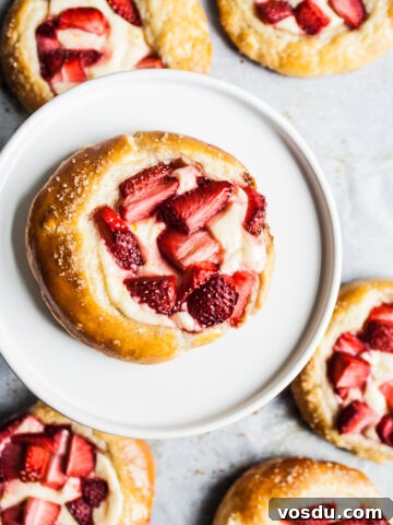 Brioche pastries with strawberries and cream cheese.