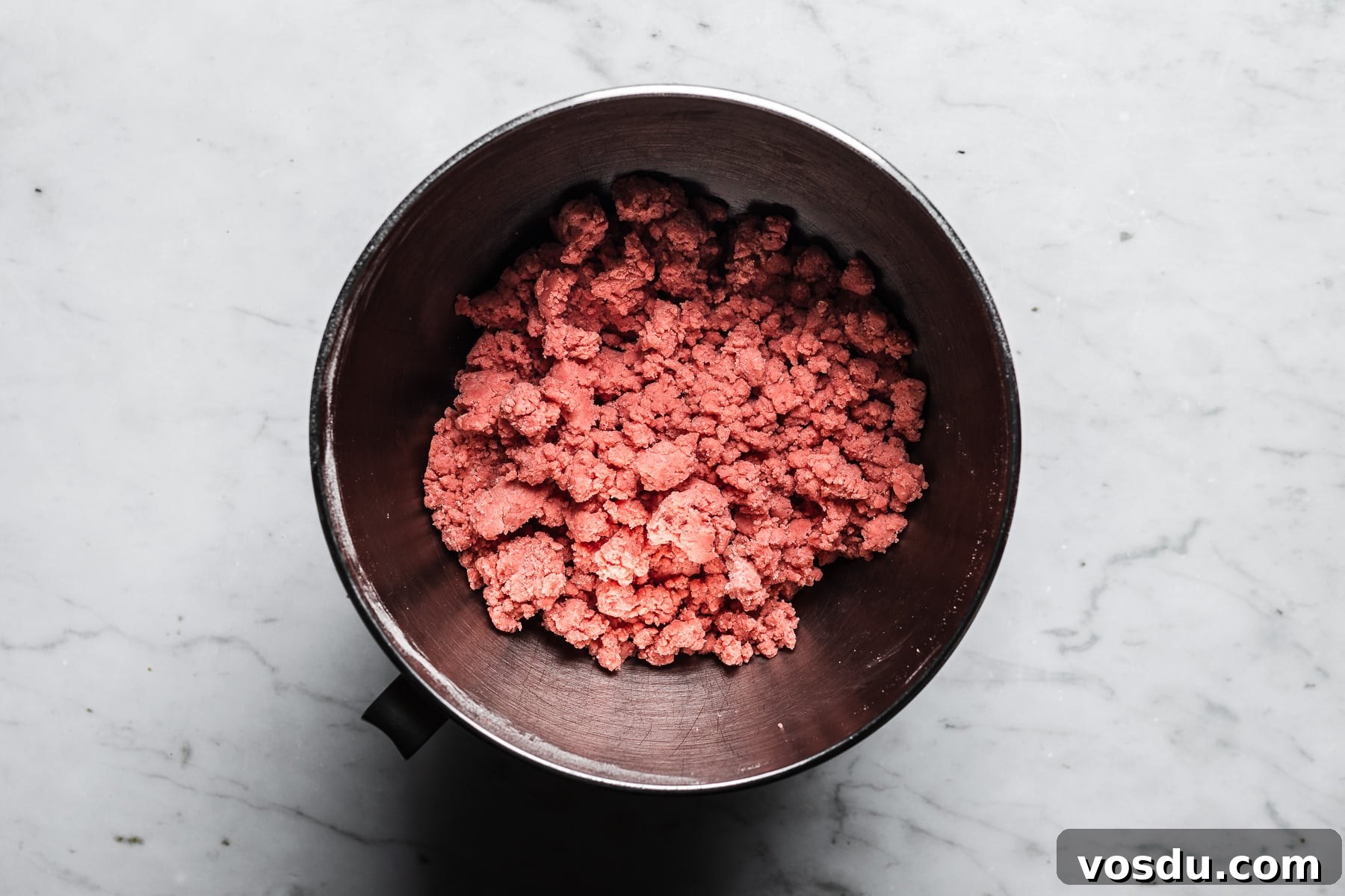 Strawberry Shortbread Cookies Recipe — Simple Homemade Treat 9 Finished pink strawberry shortbread dough in a mixing bowl.
