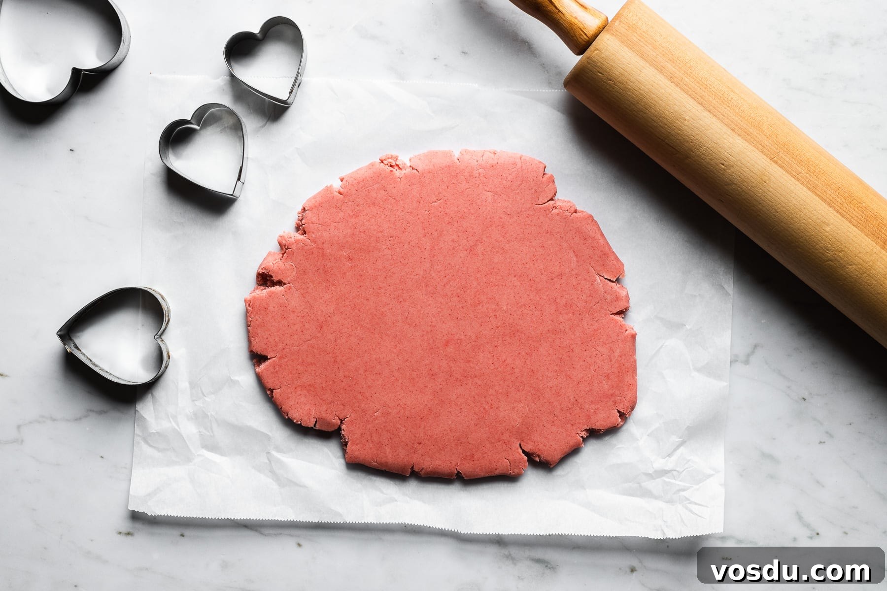 Strawberry Shortbread Cookies Recipe — Simple Homemade Treat 10 PInk shortbread dough rolled out on a rectangle of parchment paper.