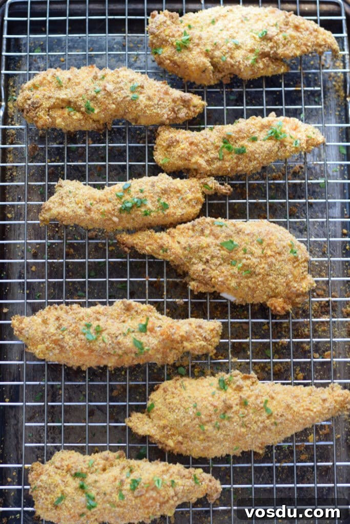 Cajun Chicken Tenders Recipe: Crispy Spicy Oven-Baked Option 9 Baked chicken tenders on a tray.
