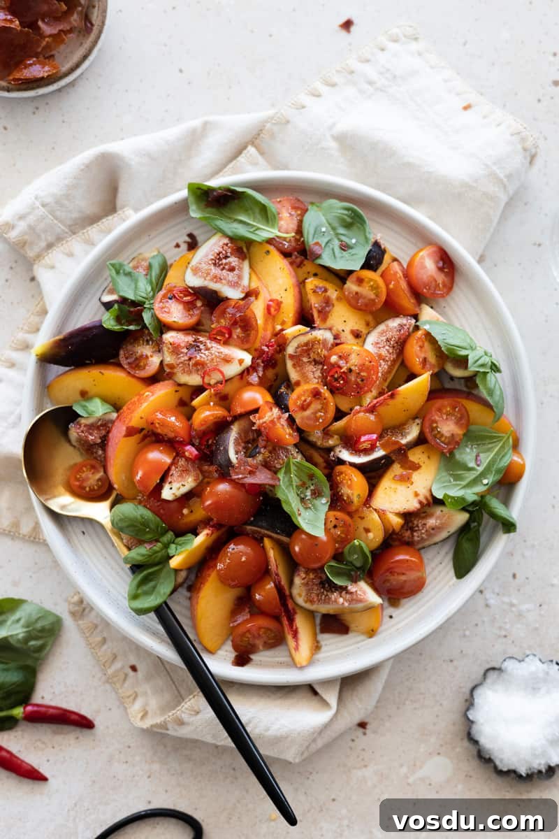 Peach and Prosciutto Salad with Burrata and Arugula 7 Final Peach and Prosciutto Salad on a white platter, topped with fresh basil and crumbled prosciutto.