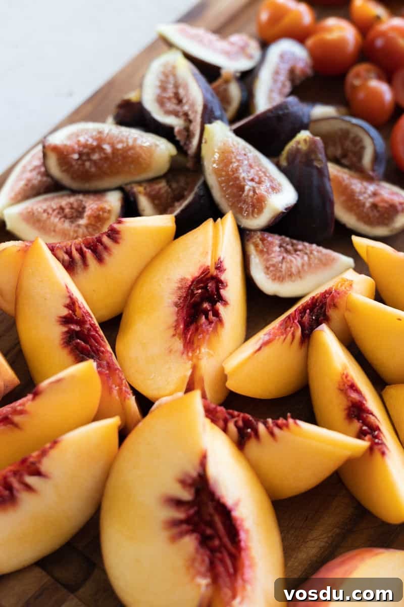 Peach and Prosciutto Salad with Burrata and Arugula 8 Sliced peaches and figs on a wooden cutting board.