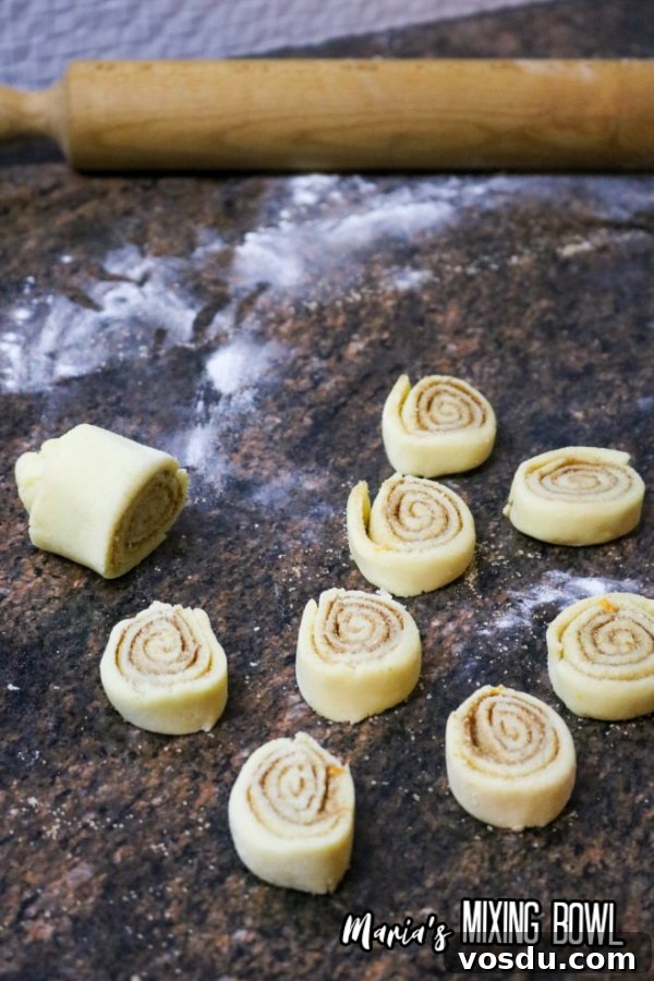 Cinnamon Roll Cookie Recipe — Soft Swirls in 30 Minutes 5 Uncooked cinnamon roll cookie dough cut into cookies