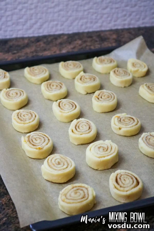 Cinnamon Roll Cookie Recipe — Soft Swirls in 30 Minutes 6 Uncooked cookies on baking sheet