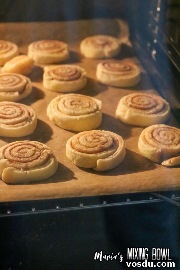 Cinnamon Roll Cookie Recipe — Soft Swirls in 30 Minutes 7 Cinnamon roll cookies baking in oven
