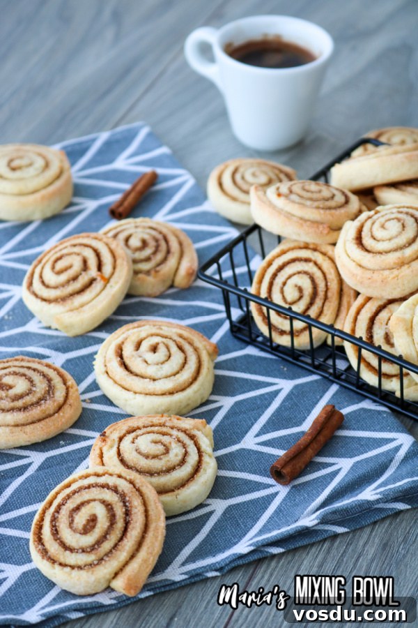 Cinnamon Roll Cookie Recipe — Soft Swirls in 30 Minutes 8 Cinnamon roll cookies with mug of coffee on table