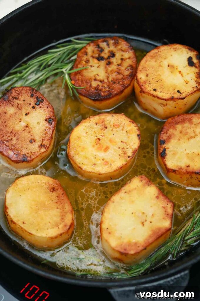 Perfect Fondant Potatoes Recipe: Crispy Edges, Tender Centers 9 fondant potatoes in a cast iron pan