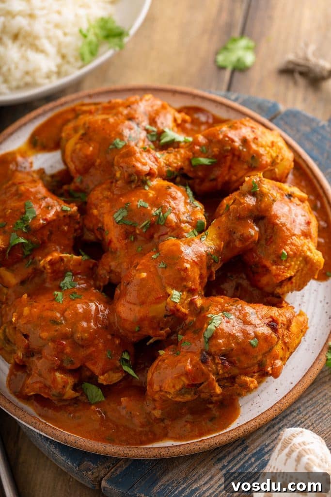 Chicken pieces in a creamy tomato masala sauce served on a plate
