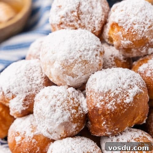 canned biscuit beignets piled on a blue and white plate