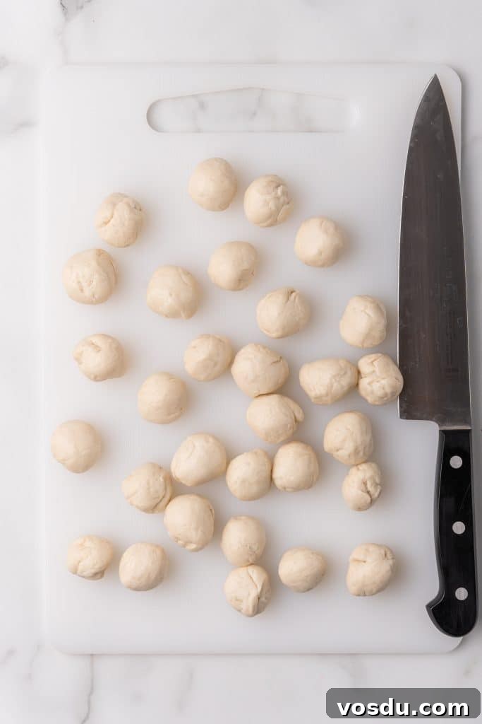 biscuit dough balls on a white cutting board