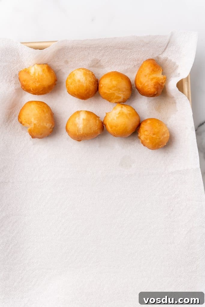 fried beignets on a paper towel lined pan