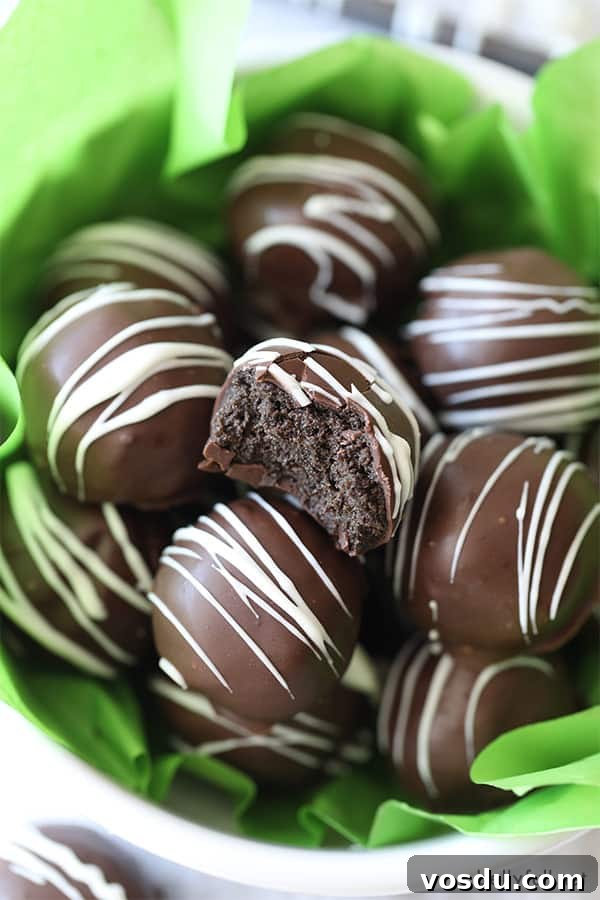 3-Ingredient Oreo Truffles — Quick No-Bake Dessert 6 bowl of Oreo Truffle Balls with one cute in half