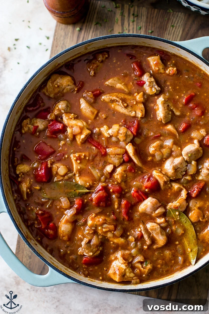 Authentic Chicken Vindaloo Recipe: Spicy Goan Curry Tutorial 3 Up close overhead photo of a skillet of chicken vindaloo