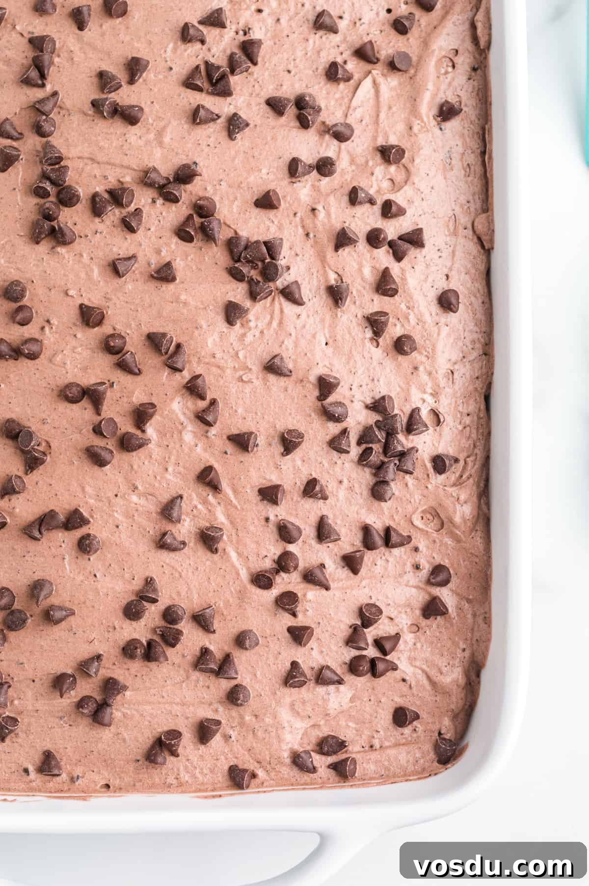 Baileys Irish Cream Poke Cake Recipe for Rich Dessert 3 cake topped with chocolate cool whip topping sprinkled with mini chocolate chips