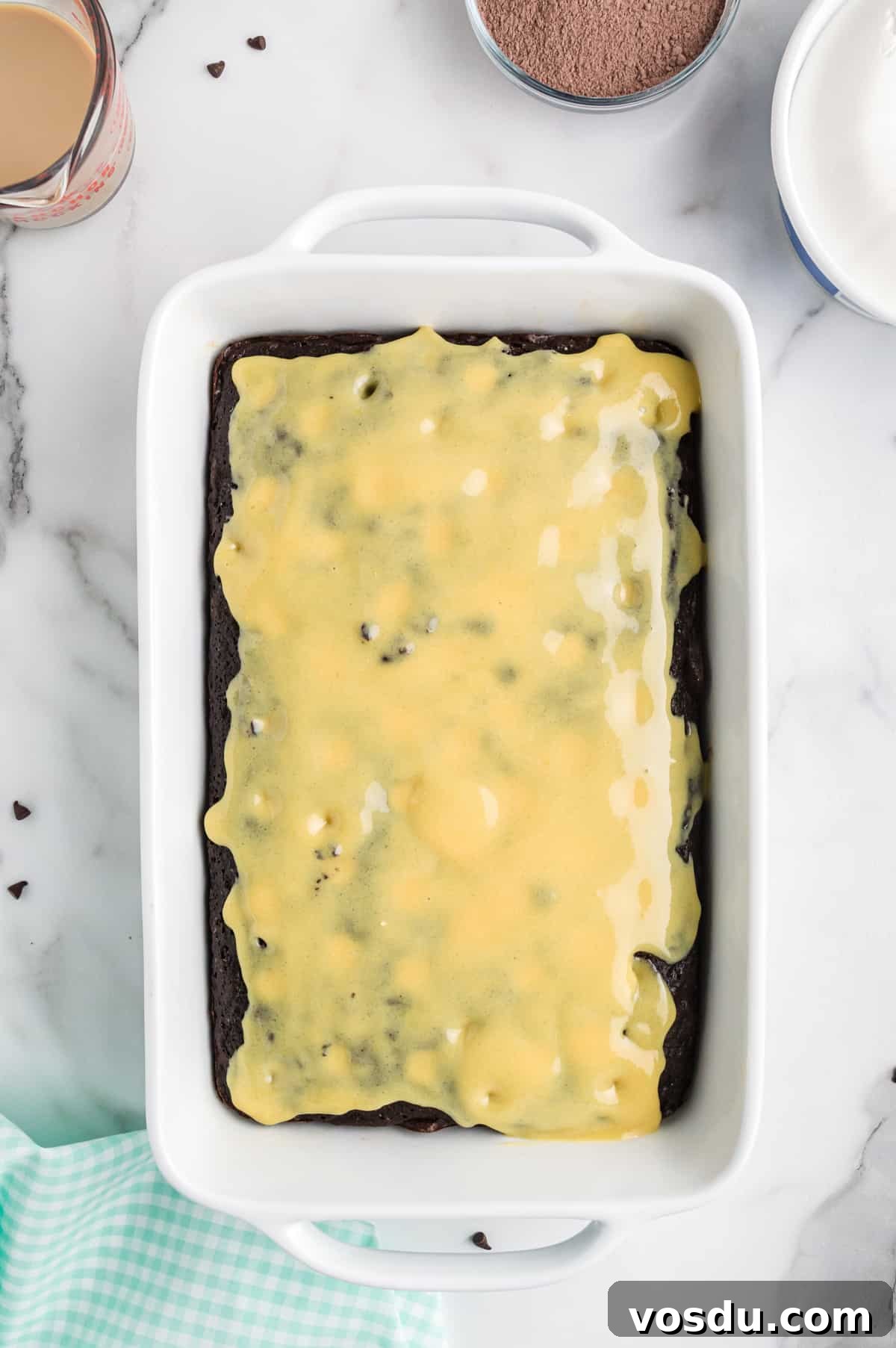 Baileys Irish Cream Poke Cake Recipe for Rich Dessert 9 chocolate poke cake topped with vanilla pudding.