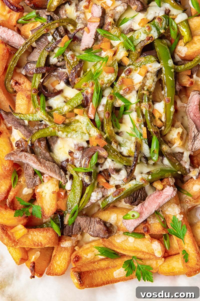 Loaded Philly Cheesesteak Fries: Steak, Cheese & Onions 5 Chunky chips topped with strips of steak, green peppers, onions and melted cheese.