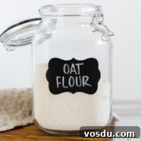 Oat flour in a labeled glass canister.