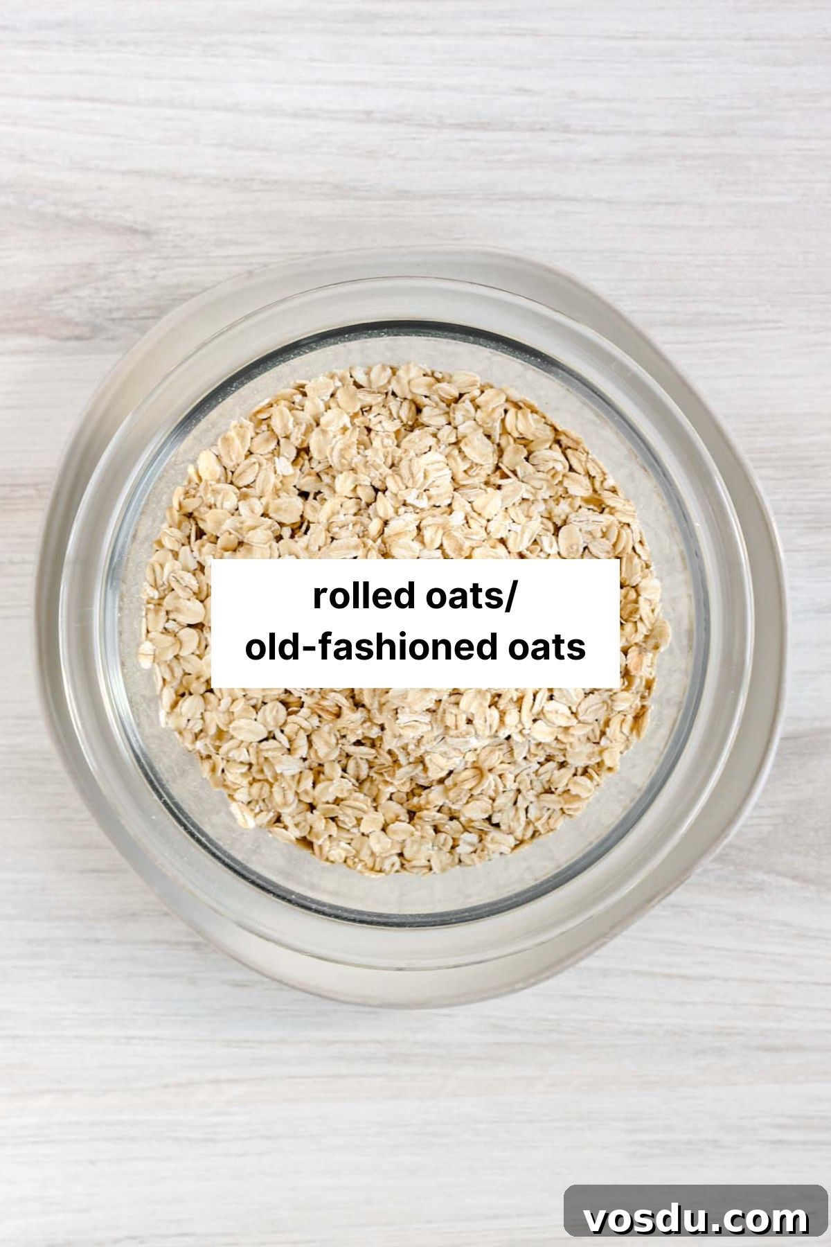Rolled oats in a glass bowl with text overlay "rolled oats/old-fashioned oats."