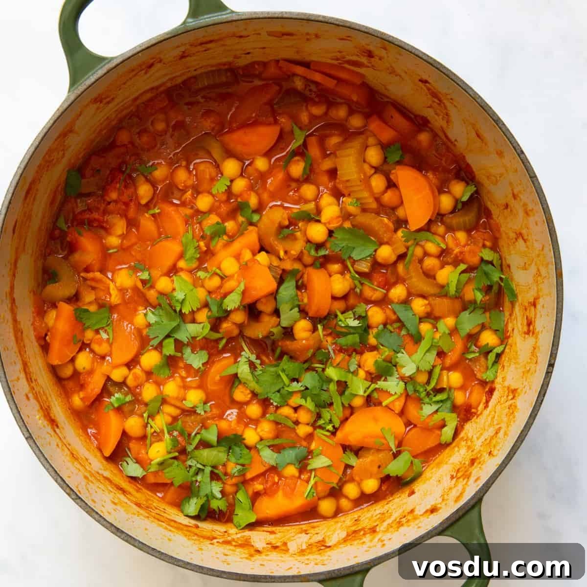 15-Minute Chickpea Stew Recipe for Quick Weeknight Dinners 2 Chickpea stew in a large pot displayed on white bakcground.