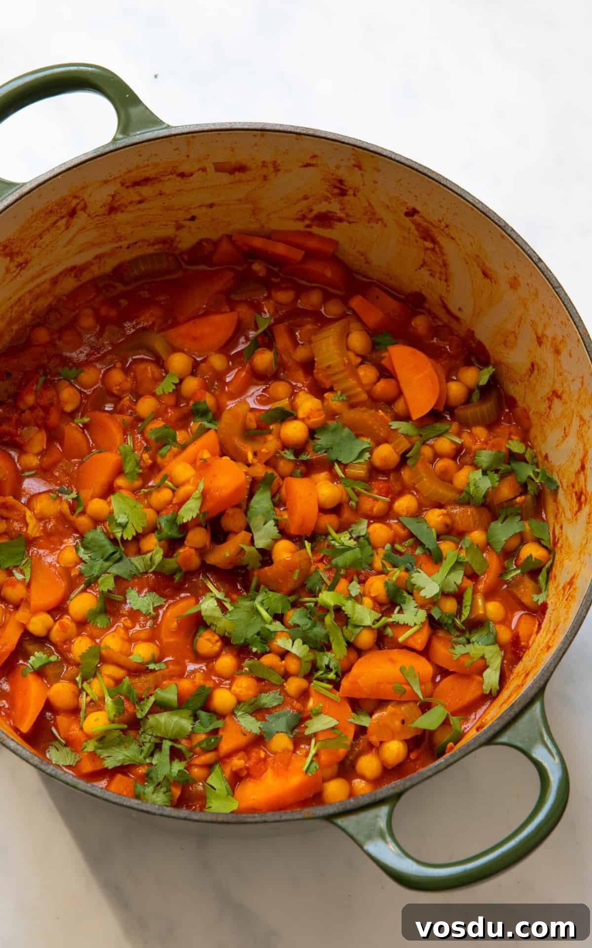 15-Minute Chickpea Stew Recipe for Quick Weeknight Dinners 6 Sweet Potato Stew in large pot on white surface.