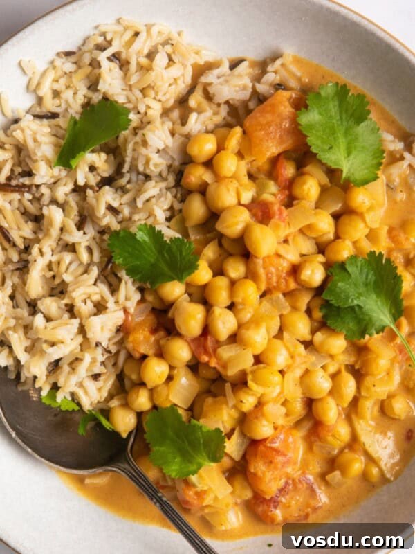 15-Minute Chickpea Stew Recipe for Quick Weeknight Dinners 10 Chickpea curry with rice in a shallow white bowl.