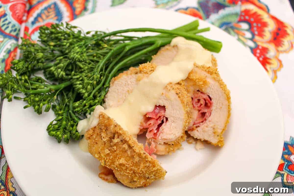 How to Safely Thaw Beef, Pork, Poultry and Seafood Quickly 2 Sliced chicken cordon bleu with dijon sauce and a side of broccolini on a plate